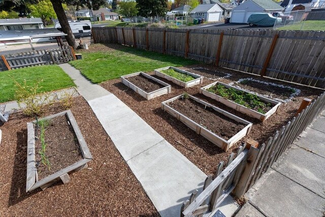 2804 W Crown Ave, Spokane, WA 99205 - view of yard with a residential view, a garden, and a garage