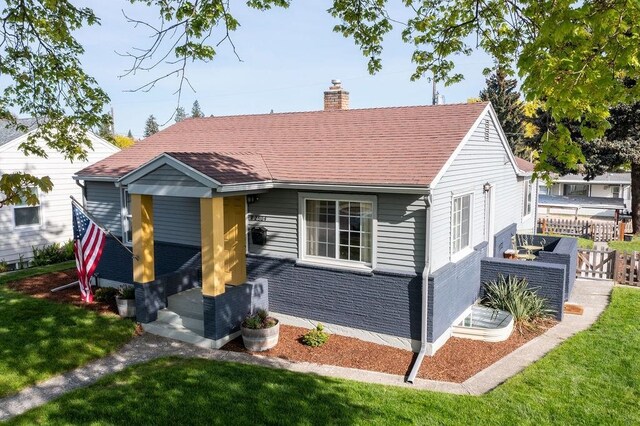 2804 W Crown Ave, Spokane, WA 99205 - view of front of house featuring a chimney, a front yard, and brick siding