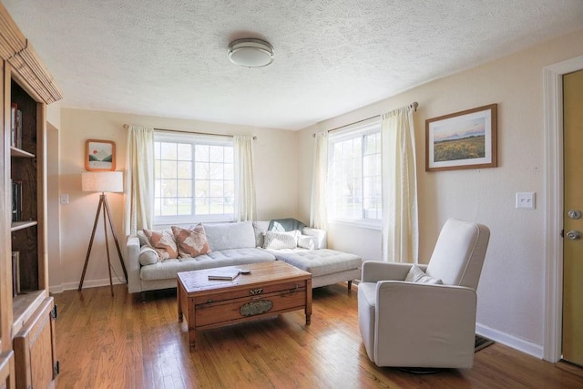 2804 W Crown Ave, Spokane, WA 99205 - living area featuring wood finished floors, baseboards, and a textured ceiling