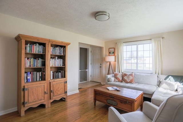 2804 W Crown Ave, Spokane, WA 99205 - living room featuring light wood-style flooring, a textured ceiling, and baseboards