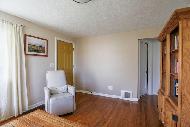 2804 W Crown Ave, Spokane, WA 99205 - sitting room with baseboards, wood finished floors, and a textured ceiling