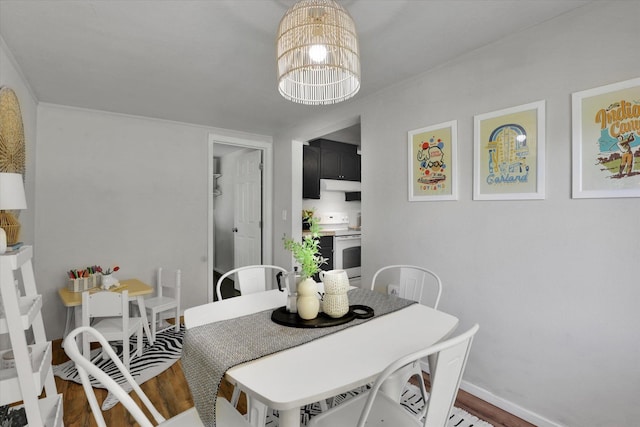 2709 E Sharp Ave, Spokane, WA 99202 - dining area featuring a chandelier, wood finished floors, and baseboards