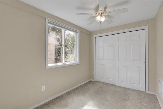 2709 E Sharp Ave, Spokane, WA 99202 - unfurnished bedroom with light colored carpet, baseboards, a closet, and a ceiling fan
