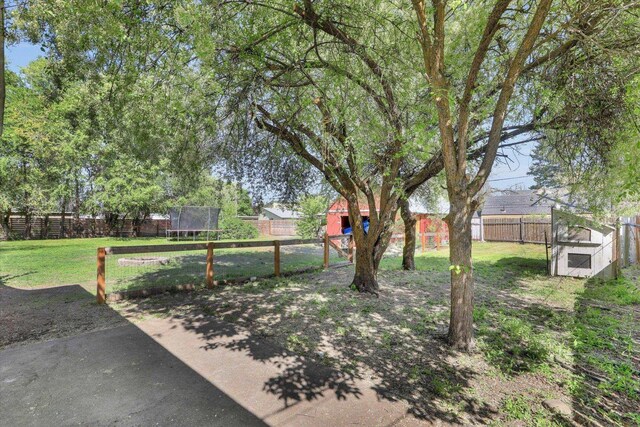 2709 E Sharp Ave, Spokane, WA 99202 - view of yard with a trampoline, an outbuilding, and a patio area