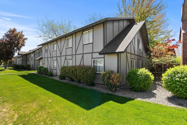 304 E Weile Ave Unit 4, Spokane, WA 99208 - rear view of property with stucco siding, a lawn, and a shingled roof