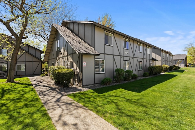304 E Weile Ave Unit 4, Spokane, WA 99208 - rear view of house featuring a yard, roof with shingles, a residential view, and stucco siding