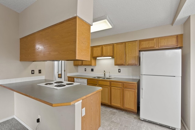 304 E Weile Ave Unit 4, Spokane, WA 99208 - kitchen featuring white appliances, a textured ceiling, a peninsula, a sink, and brown cabinetry
