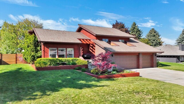 view of front of home featuring a tile roof, driveway, and a garage