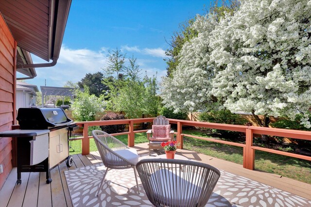wooden terrace with a grill