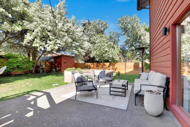 view of patio featuring outdoor lounge area, a storage shed, and an outdoor structure
