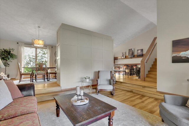 living room featuring wood finished floors and stairway