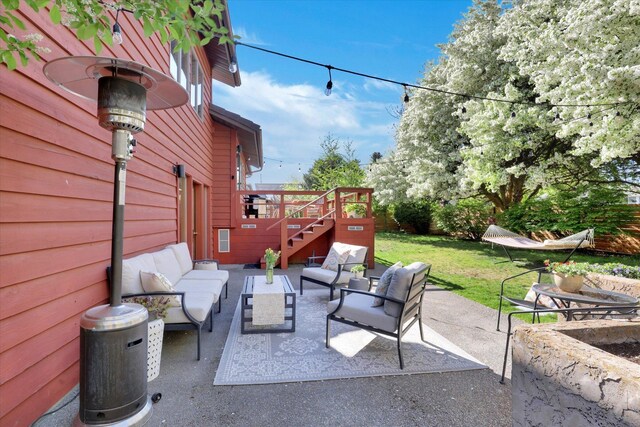 view of patio with an outdoor living space, stairs, and a wooden deck