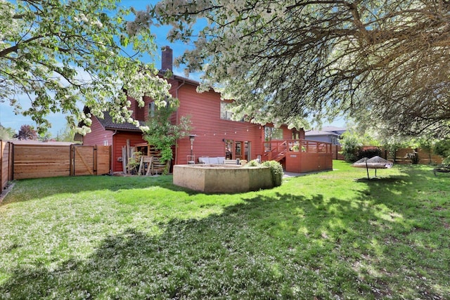 view of yard with a deck and a gate