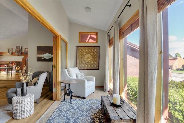 sitting room with lofted ceiling and wood finished floors