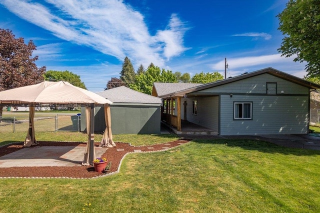 view of yard with a gazebo, a patio area, and a detached carport