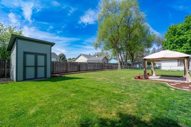 view of yard with a gazebo, a storage shed, and an outdoor structure