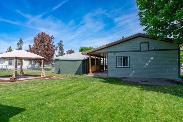 back of house featuring a gazebo