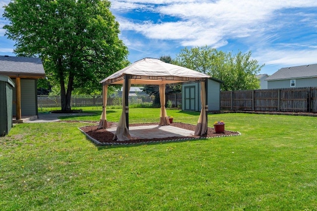 view of yard featuring a gazebo, a patio, a storage shed, and an outdoor structure
