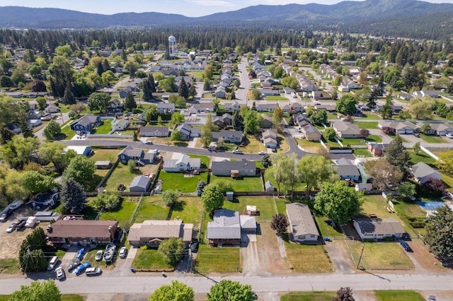 aerial view of property's location featuring a mountain backdrop and nearby suburban area