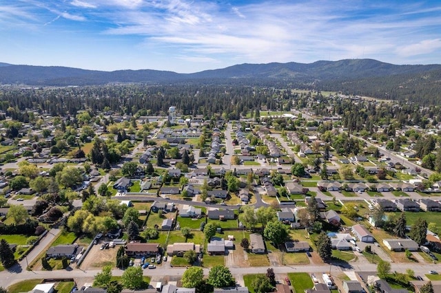 aerial overview of property's location featuring a mountain backdrop and nearby suburban area