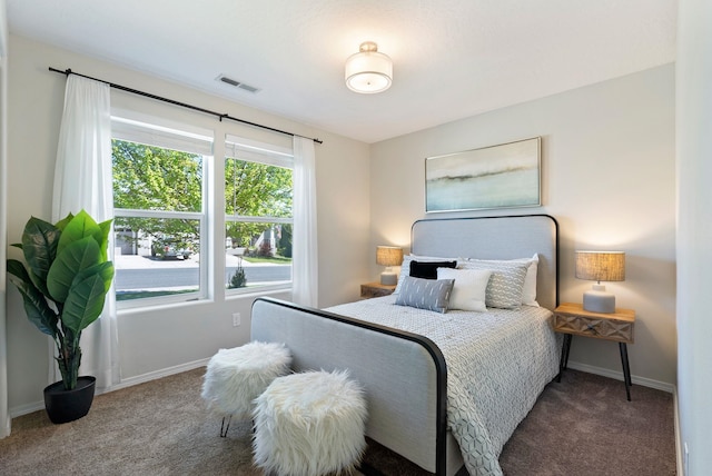 bedroom featuring carpet and baseboards