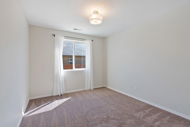 unfurnished room featuring carpet floors and baseboards