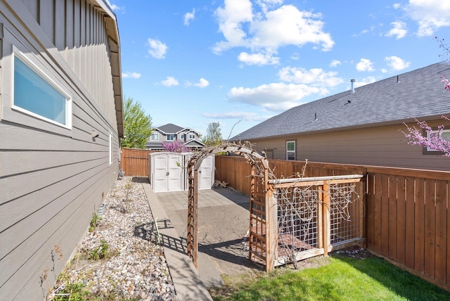 fenced backyard featuring an outdoor structure and a storage shed