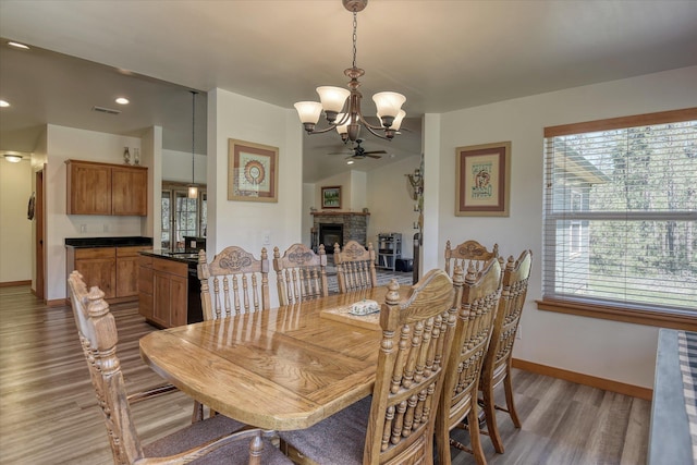 dining room with a chandelier, light wood-type flooring, baseboards, healthy amount of natural light, and recessed lighting