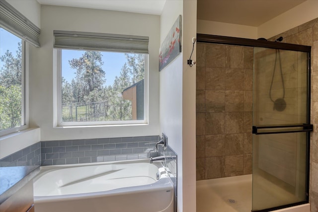 full bath featuring a stall shower and a garden tub