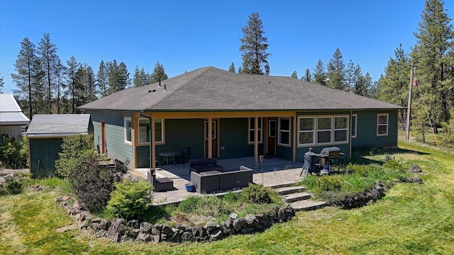 back of house with a patio, an outdoor living space with a fire pit, a yard, and a shingled roof