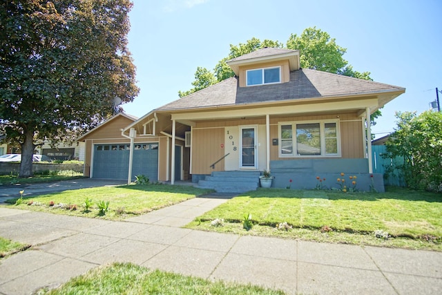 1018 E Broad Ave, Spokane, WA 99207 - view of front of property featuring an attached garage, a front yard, asphalt driveway, a shingled roof, and a porch