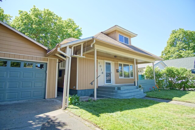 1018 E Broad Ave, Spokane, WA 99207 - view of front of home featuring covered porch, concrete driveway, and a front yard