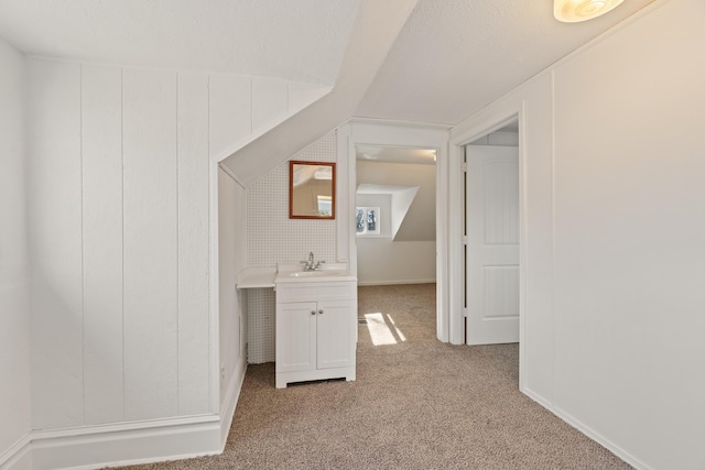 1018 E Broad Ave, Spokane, WA 99207 - additional living space with light carpet, a sink, and lofted ceiling