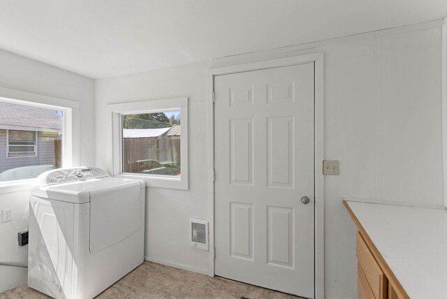 laundry room featuring washer / dryer and cabinet space