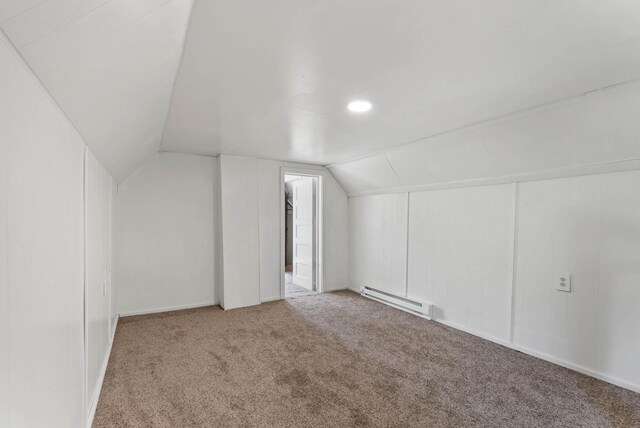 bonus room featuring a baseboard heating unit, carpet flooring, and lofted ceiling