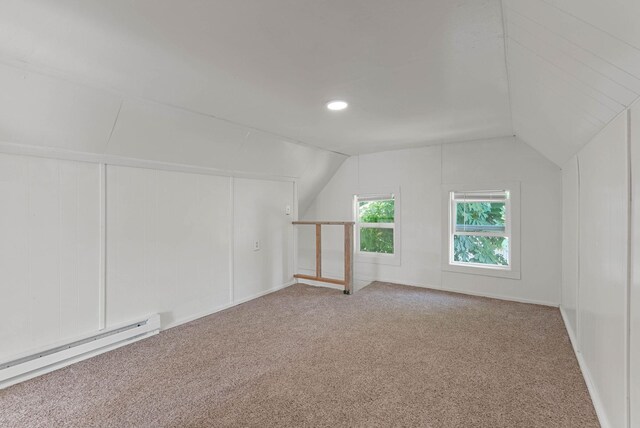 additional living space featuring a baseboard heating unit, lofted ceiling, carpet flooring, and recessed lighting
