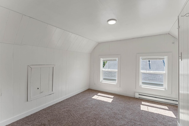 additional living space featuring a baseboard heating unit, lofted ceiling, and carpet floors