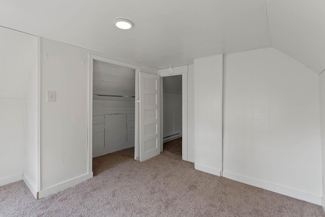 unfurnished bedroom with carpet floors, a spacious closet, baseboards, and a closet