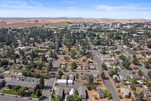 aerial view of property and surrounding area with mountains and nearby suburban area