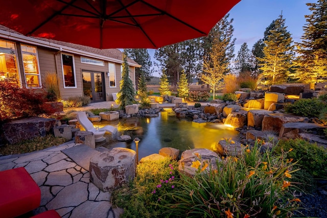 21621 N Lang Ln, Chattaroy, WA 99003 - view of patio / terrace with a garden pond and french doors