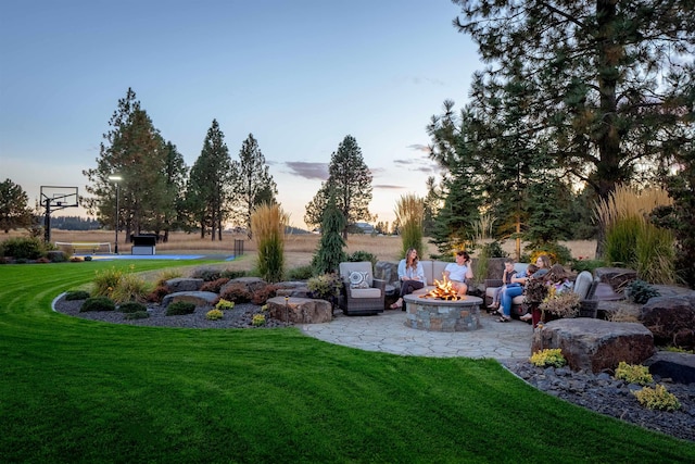 21621 N Lang Ln, Chattaroy, WA 99003 - yard at dusk with a lawn and an outdoor fire pit