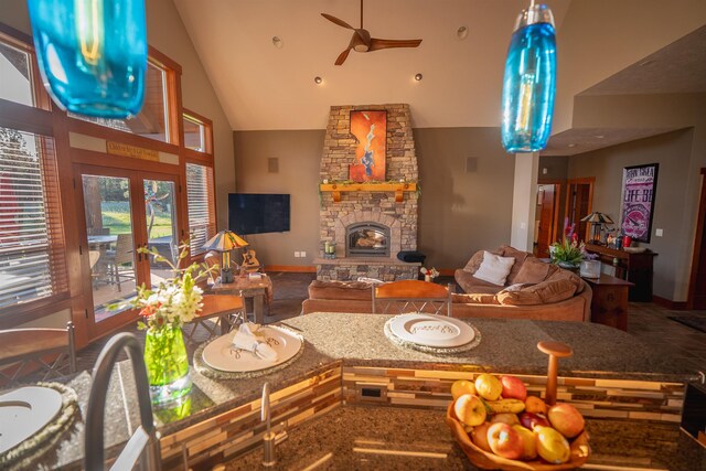 21621 N Lang Ln, Chattaroy, WA 99003 - living area with high vaulted ceiling, a ceiling fan, a stone fireplace, baseboards, and recessed lighting