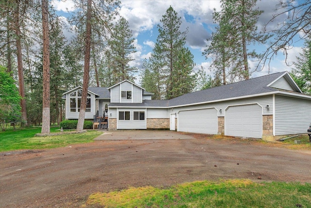 14512 N Dartford Dr, Spokane, WA 99208 - tri-level home featuring stone siding, an attached garage, dirt driveway, and a shingled roof