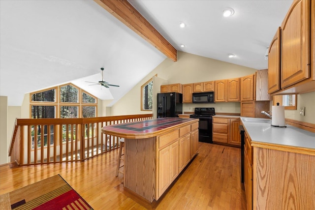 14512 N Dartford Dr, Spokane, WA 99208 - kitchen with black appliances, light wood finished floors, beamed ceiling, a center island, and ceiling fan