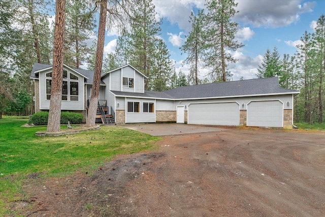 14512 N Dartford Dr, Spokane, WA 99208 - view of front of property featuring stone siding, an attached garage, driveway, and a front lawn