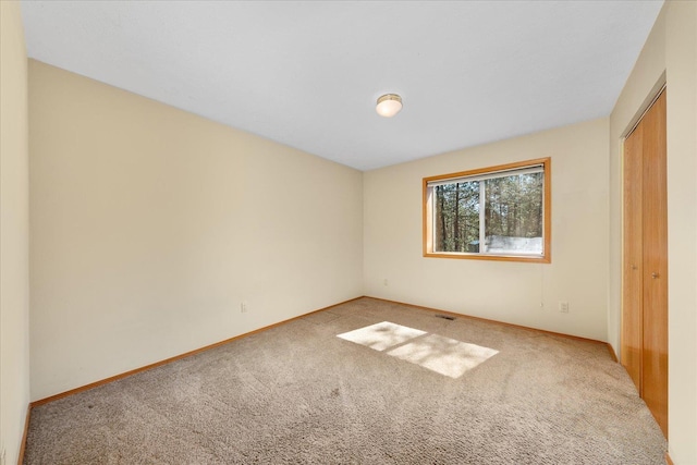 14512 N Dartford Dr, Spokane, WA 99208 - unfurnished bedroom with light carpet, a closet, and baseboards