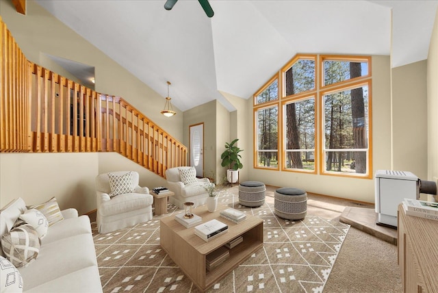 14512 N Dartford Dr, Spokane, WA 99208 - carpeted living room featuring high vaulted ceiling, stairway, and ceiling fan