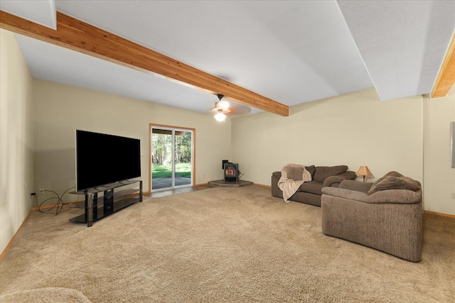 14512 N Dartford Dr, Spokane, WA 99208 - carpeted living area featuring a wood stove, beamed ceiling, and baseboards