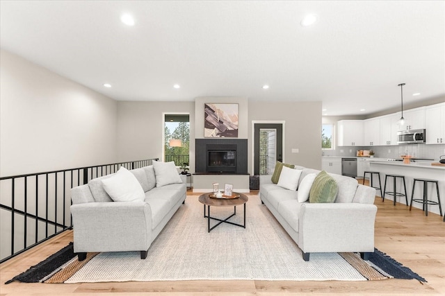 4243 W Tolliver Ct, Spokane, WA 99208 - living area featuring light wood-style floors, recessed lighting, and a glass covered fireplace