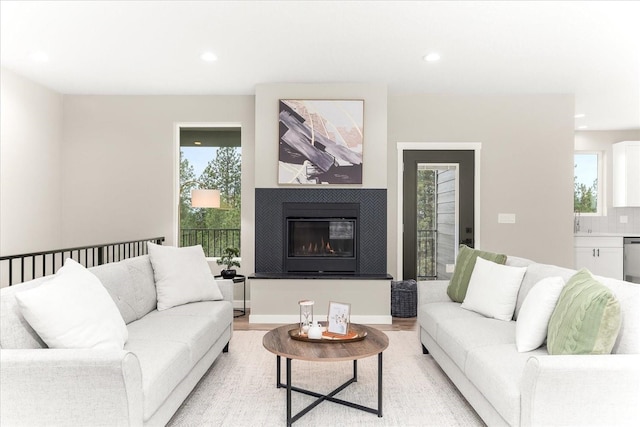 4243 W Tolliver Ct, Spokane, WA 99208 - living area with a glass covered fireplace, light wood-style flooring, and recessed lighting